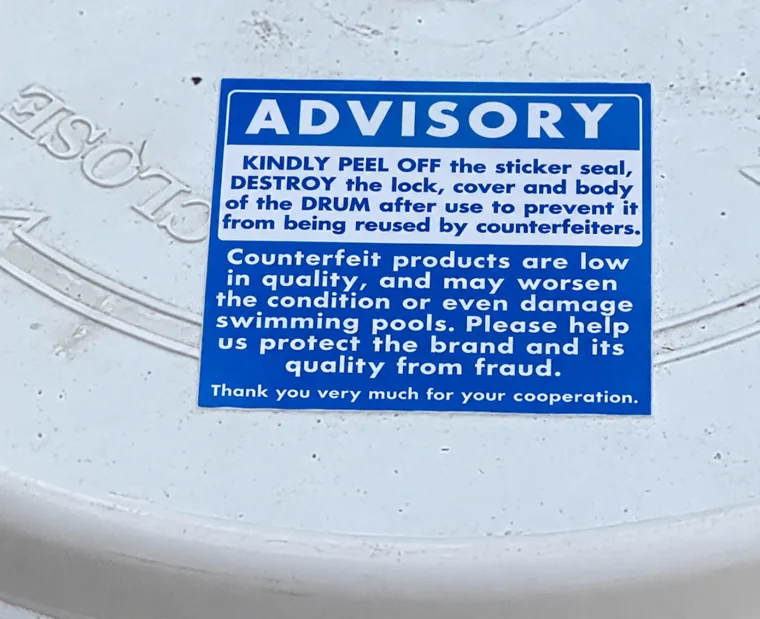The blue ADVISORY sticker on the lid of a Fuji-Chlon drum